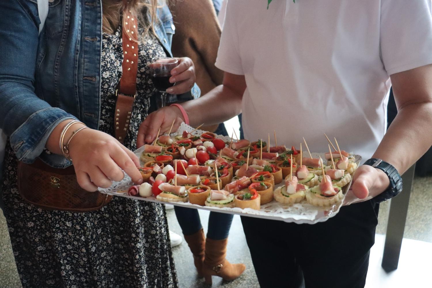 Un ouvrier sert des petits fours lors d'une réception.