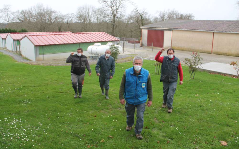 Les ouvriers du Château Bellevue marchent devant les bâtiments qui abritent normalement les vollailles.